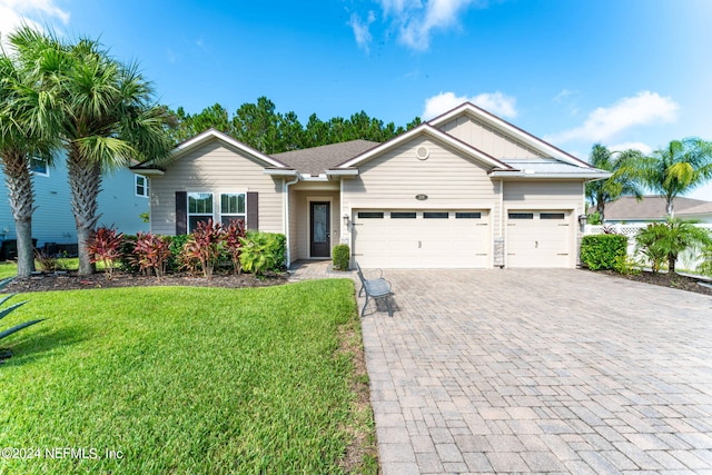 ranch-style house with a garage, decorative driveway, and a front yard