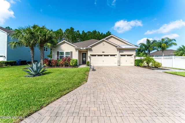 ranch-style home with a front lawn and a garage