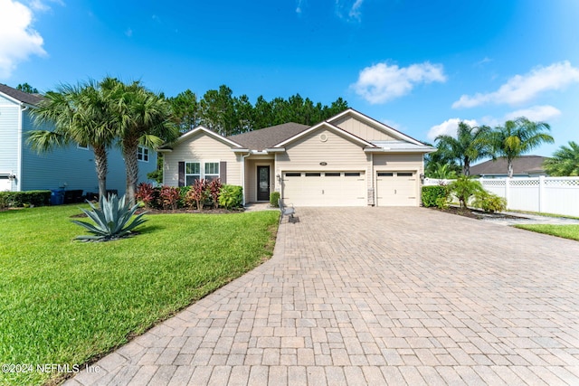 single story home featuring a garage, fence, a front lawn, and decorative driveway