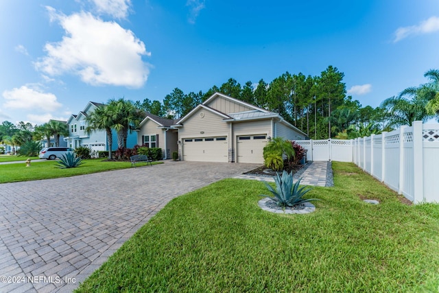 ranch-style house featuring decorative driveway, board and batten siding, fence, a garage, and a front lawn