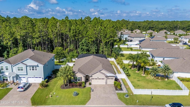 birds eye view of property featuring a wooded view and a residential view