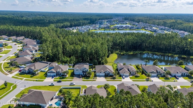 birds eye view of property featuring a residential view, a water view, and a view of trees