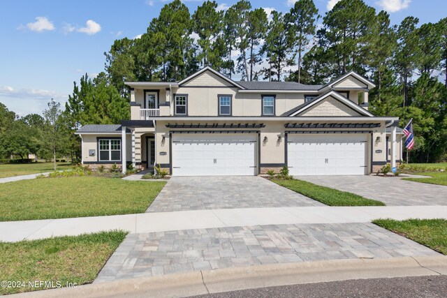 view of front of property featuring a garage and a front yard