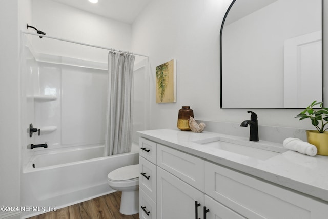 full bathroom with vanity, shower / bath combo with shower curtain, toilet, and hardwood / wood-style floors