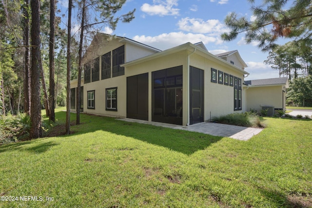 back of house with a lawn