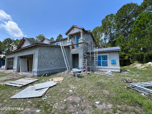 view of front of house featuring a garage and a patio