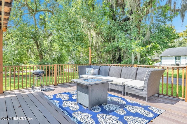 deck featuring a grill and an outdoor living space with a fire pit