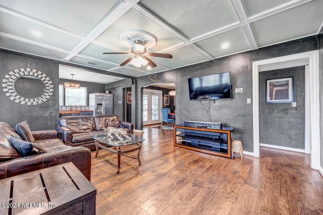 living room with french doors, coffered ceiling, ceiling fan, wood-type flooring, and beamed ceiling