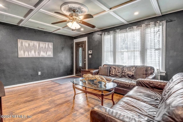 living room with hardwood / wood-style floors, ceiling fan, coffered ceiling, and beam ceiling