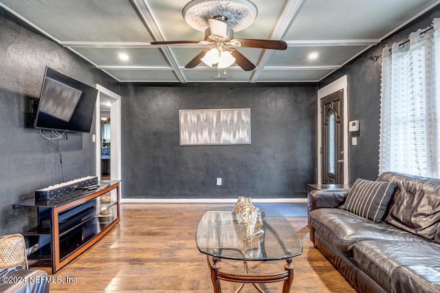 living room with beam ceiling, ceiling fan, coffered ceiling, hardwood / wood-style floors, and ornamental molding