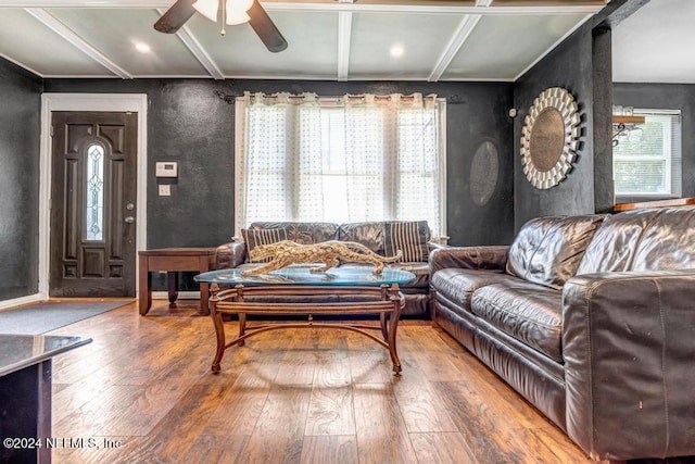 living room with ceiling fan, hardwood / wood-style floors, and beamed ceiling