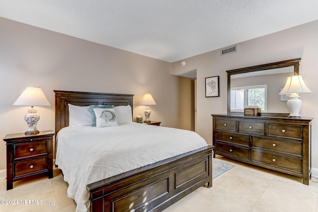 bedroom with visible vents and light tile patterned floors