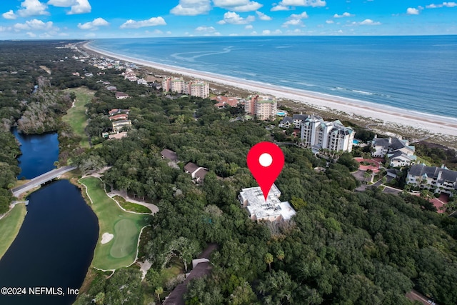 birds eye view of property with a beach view and a water view