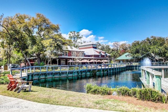 exterior space with a water view and a pier