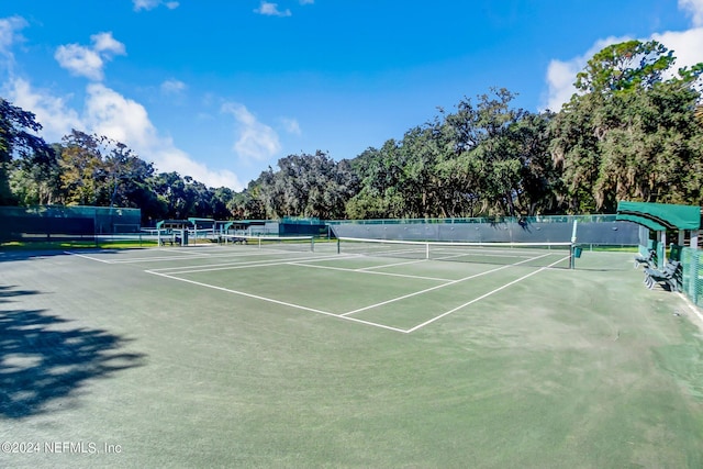 view of tennis court featuring fence