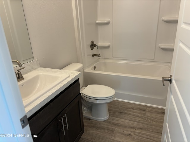 full bathroom featuring vanity, wood-type flooring, tub / shower combination, and toilet