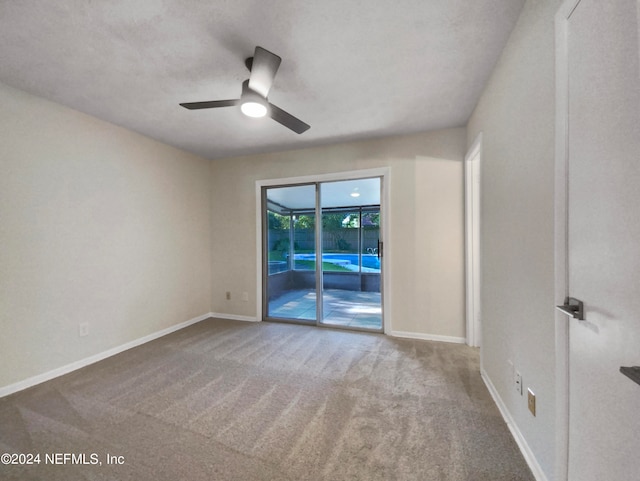 empty room with carpet and ceiling fan