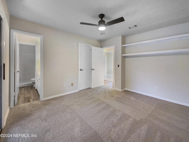 unfurnished bedroom featuring light colored carpet, visible vents, baseboards, and ensuite bathroom