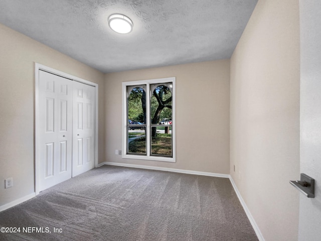 unfurnished bedroom featuring a closet, carpet flooring, and baseboards