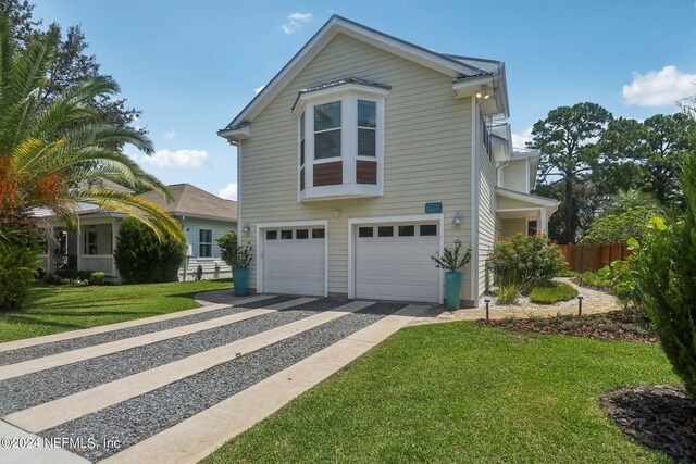 view of front facade with a garage and a front lawn