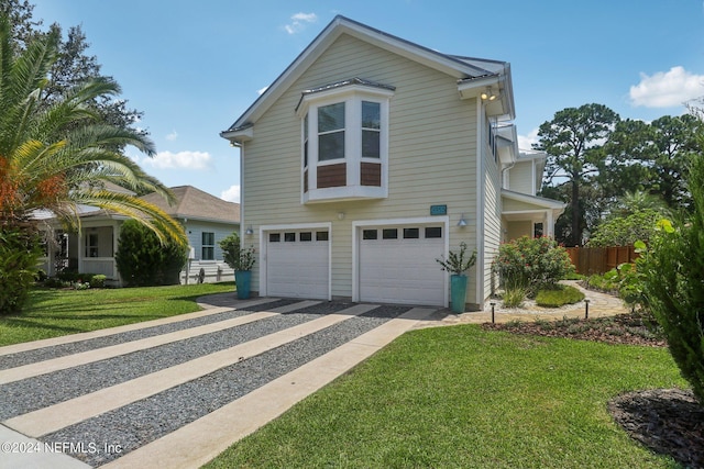 view of front of house with a garage and a front yard