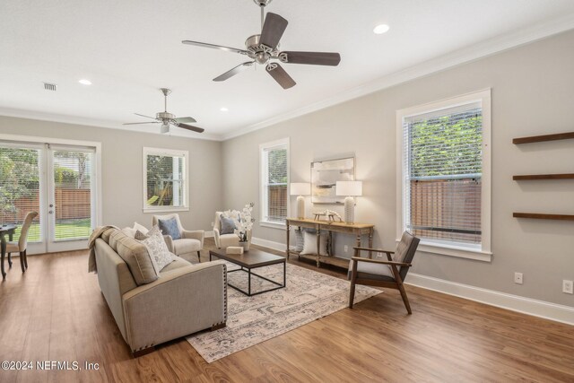 living room featuring a healthy amount of sunlight, ceiling fan, and light hardwood / wood-style floors