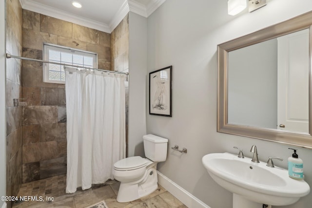 bathroom featuring crown molding, toilet, sink, and a shower with shower curtain