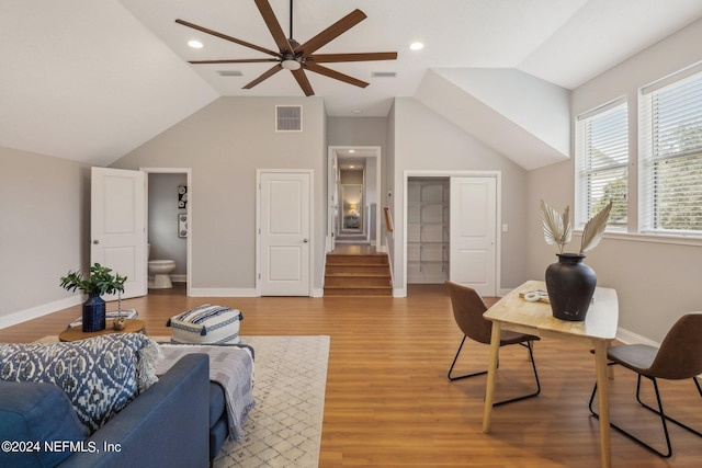 living room featuring hardwood / wood-style flooring and lofted ceiling