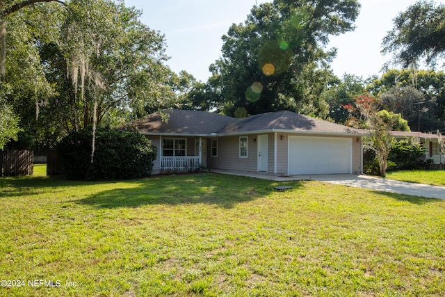 ranch-style house featuring a garage and a front yard