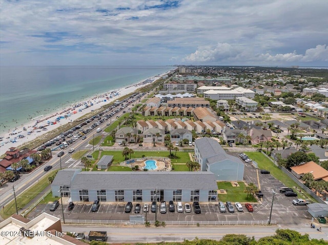 drone / aerial view featuring a water view and a beach view