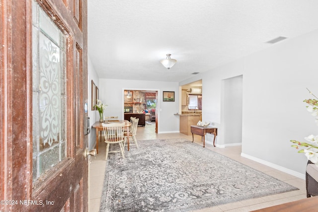 interior space with visible vents, a textured ceiling, and baseboards