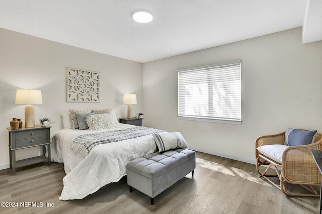 bedroom with hardwood / wood-style flooring