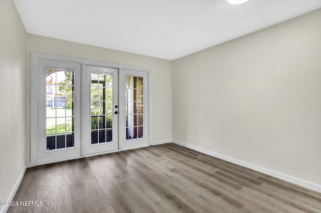 spare room with hardwood / wood-style floors