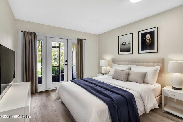 bedroom with hardwood / wood-style flooring and access to exterior