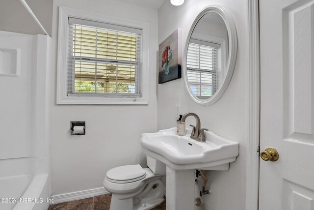 bathroom with toilet and bathing tub / shower combination