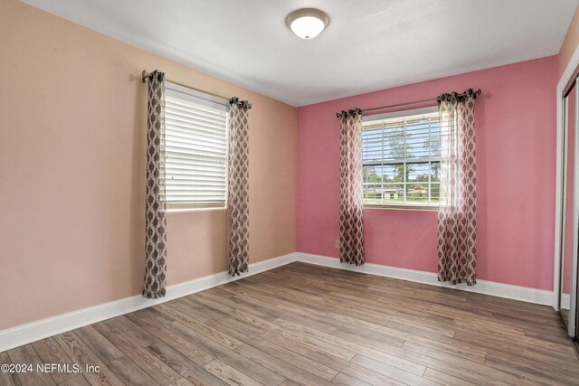 unfurnished room with hardwood / wood-style floors