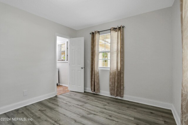 spare room with hardwood / wood-style floors