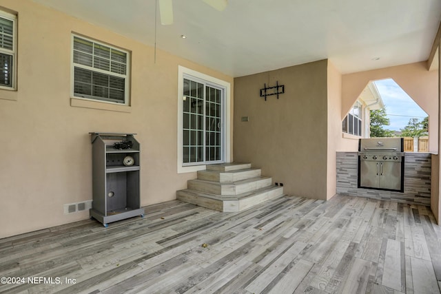 doorway to property with ceiling fan