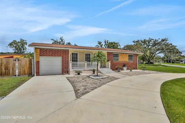 ranch-style home with a front lawn, a porch, and a garage