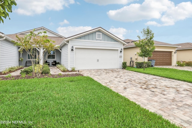 single story home with a garage and a front yard