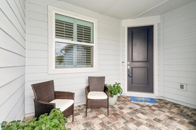 entrance to property with a patio