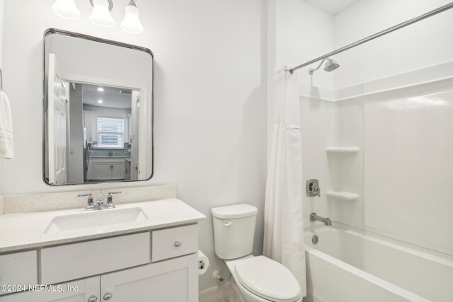 full bathroom with vanity, shower / tub combo, and toilet