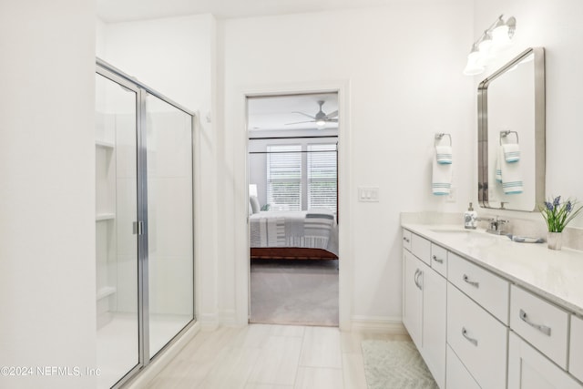 bathroom featuring tile patterned floors, a shower with shower door, vanity, and ceiling fan