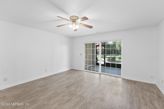 unfurnished room with hardwood / wood-style flooring and ceiling fan