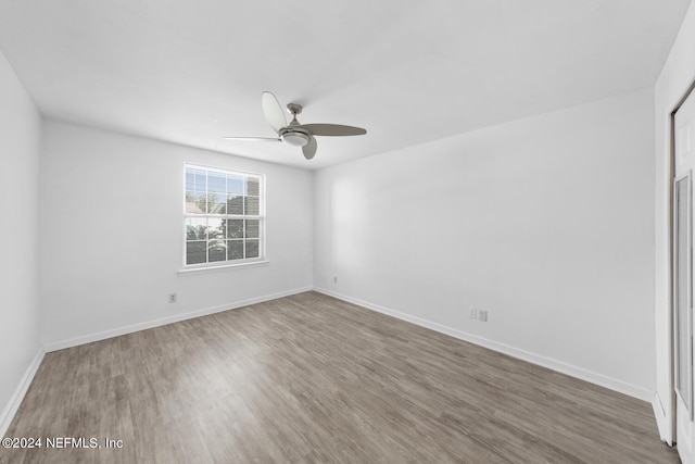 spare room with hardwood / wood-style flooring and ceiling fan