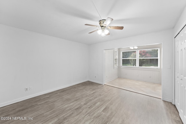 unfurnished bedroom with ceiling fan, light hardwood / wood-style floors, and a closet