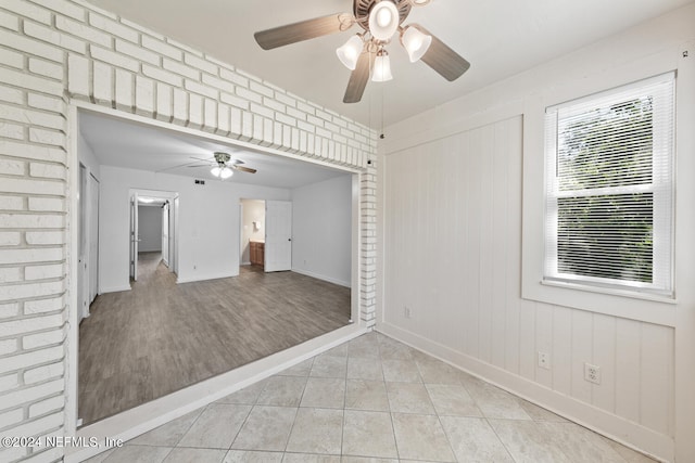 unfurnished room with ceiling fan and light tile patterned floors