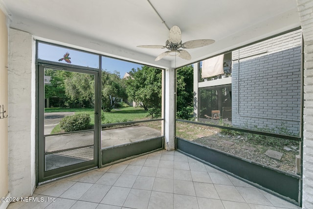 unfurnished sunroom with ceiling fan