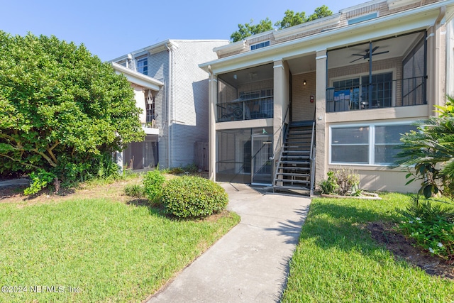 exterior space with a yard and ceiling fan