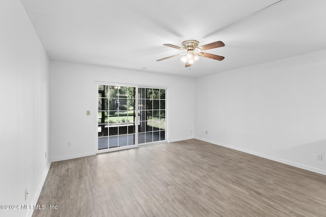 spare room with wood-type flooring and ceiling fan